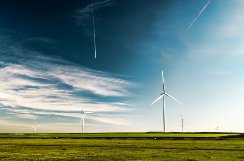 Green Energy - photo of wind turbines on green grass