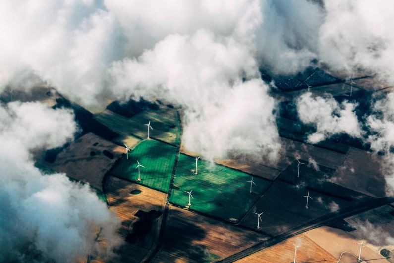 Green Energy - aerial photo of wind turbines near field