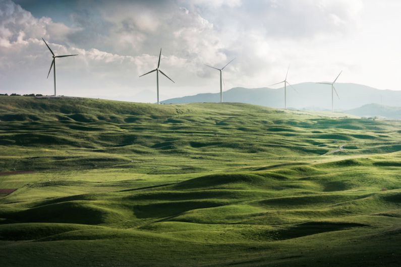 Green Energy - wind turbine surrounded by grass